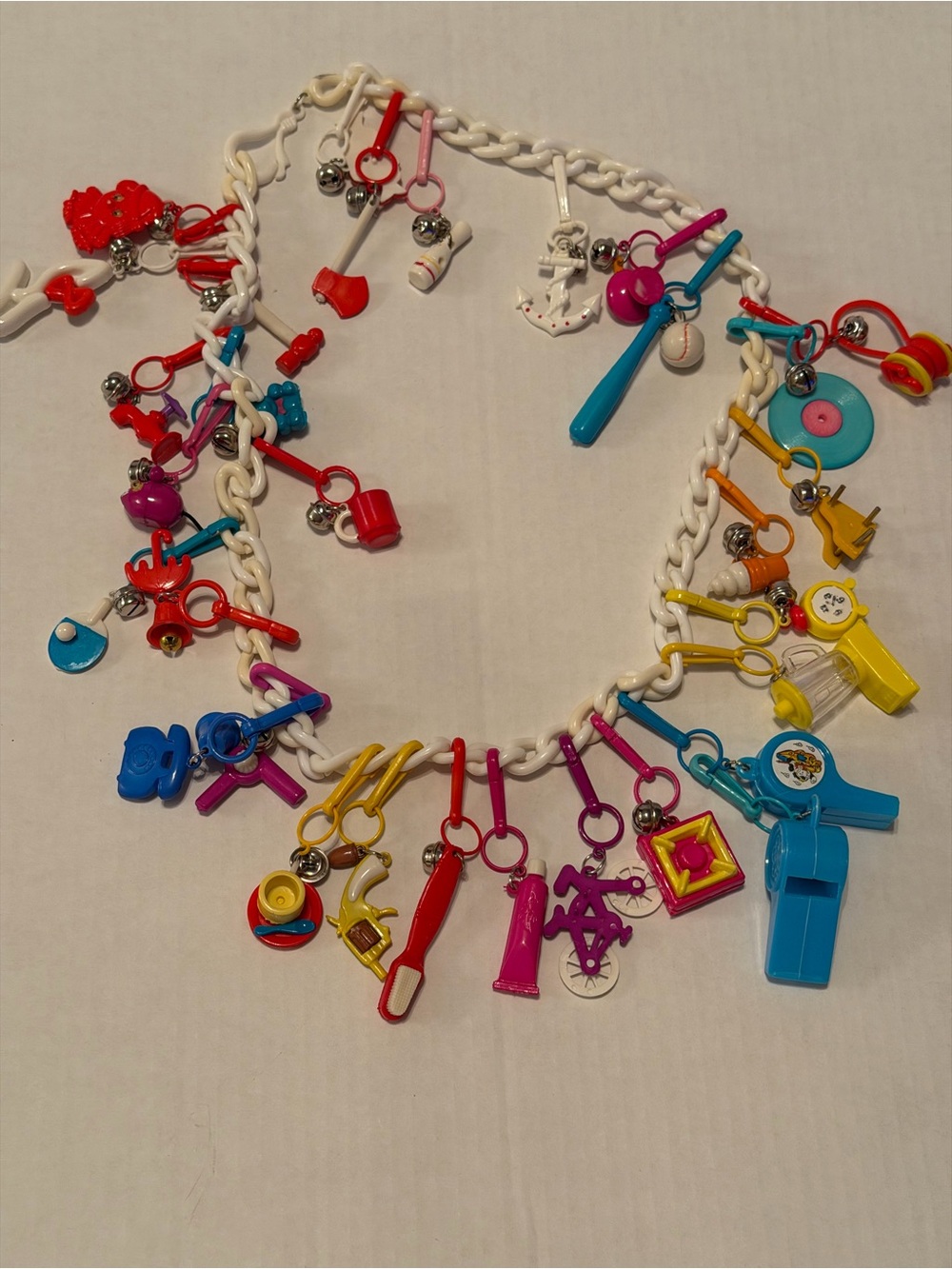 Vintage 80s bell charm plastic necklace with 30 charms